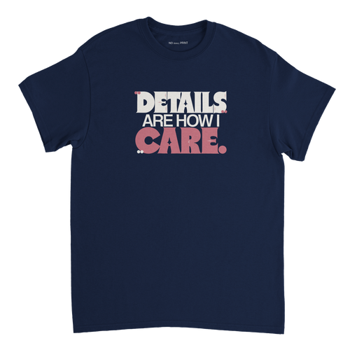 Front of a T-shirt with the Details Are How I Care design in berry and porcelain typography with small detail marks